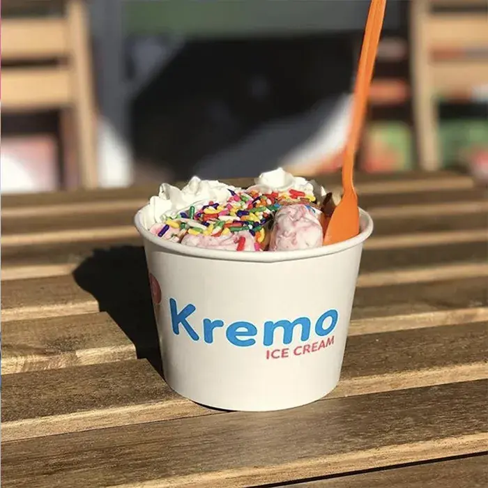 Kremo ice cream on the table with spoon on it